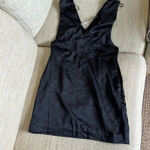 Cute little black dress with cut out in the front.